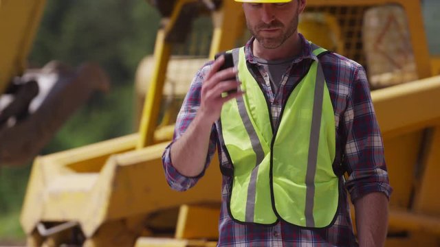 Construction worker talking on cell phone