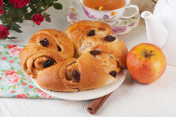 roll with apple and cinnamon raisin in a still life on  plate  bright