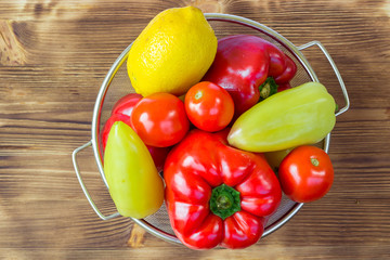 Vegetable still life of peppers, tomatoes, lemon in bowl