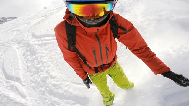 Snowboard fail, snowboarding in powder and falling down in deep snow, face view
