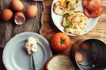 Scrambled, fried, boiled eggs on a wooden table
