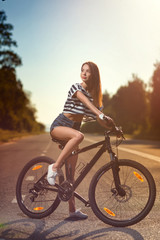 Fototapeta na wymiar girl on a bicycle at sunset
