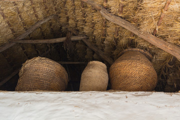 Wicker baskets under a thatched roof in the Ukrainian peasant dw