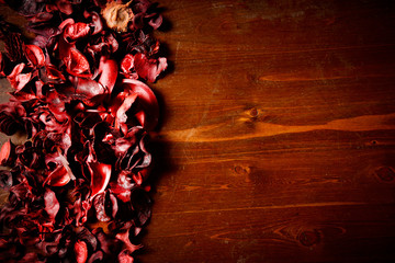 red scented potpourri  on dark wooden table