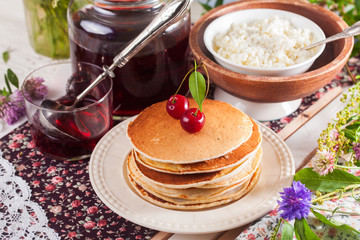 Obraz na płótnie Canvas pancakes with cherry flowers still life summer
