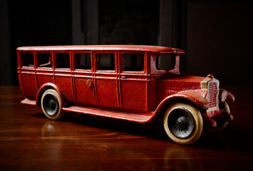 red vintage toy truck  on dark wooden table