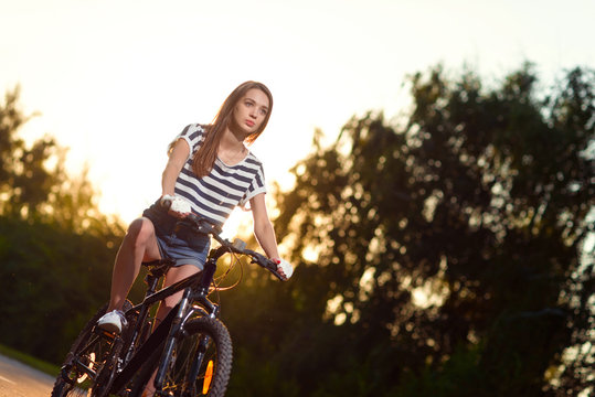 girl on a bicycle at sunset
