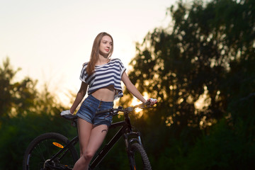 girl on a bicycle at sunset