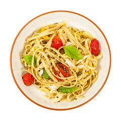 Pasta With Pesto and Roasted Tomatoes Isolated on White. Selective focus.