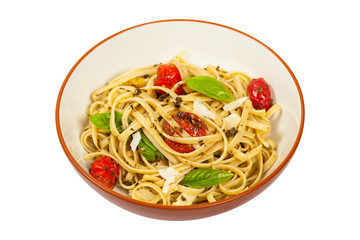 Pasta With Pesto and Roasted Tomatoes Isolated on White. Selective focus.