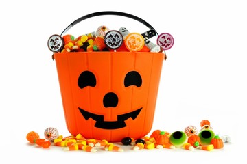 Halloween Jack o Lantern candy collector with scattered candy over a white background