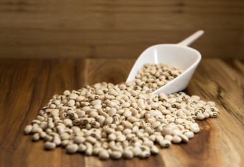 Black eyed peas beans on wooden background. Selective focus.