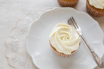 rose flower vanilla cupcakes on vintage plate