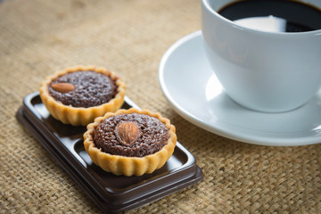 Coffee cup and coffee beans with brownie tarts
