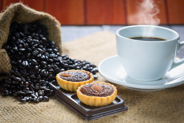 Coffee cup and coffee beans with brownie tarts