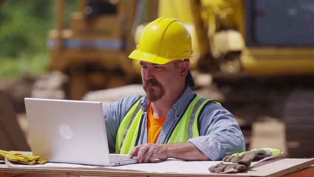 Construction worker using laptop computer