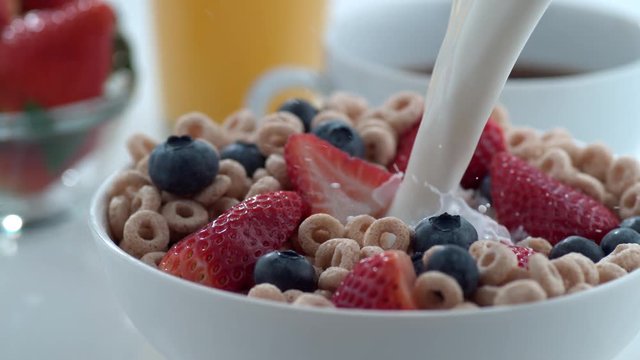 Milk pouring into bowl of cereal with berries, slow motion; shot on Phantom Flex 4K at 1000 fps