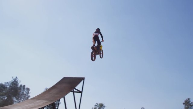 Motocross rider going off big jump, slow motion, 4K shot on RED Epic