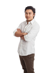 Handsome man standing with arms crossed wearing a white shirt and khaki pants. White background.
