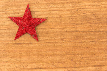Fototapeta na wymiar Bright red Christmas star on a wooden background