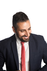 An attractive businessman in his 40s wearing a blue suit with a red tie, standing against a white background with a smile on his face.