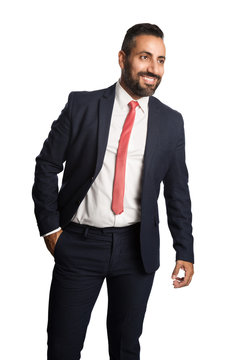 An attractive businessman in his 40s wearing a blue suit with a red tie, standing against a white background with a smile on his face.