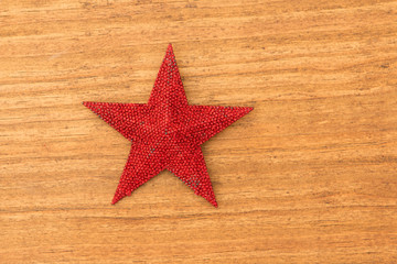 Fototapeta na wymiar Bright red Christmas star on a wooden background