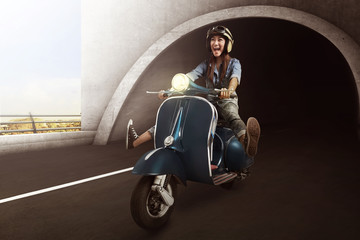 Asian woman with helmet riding scooter © Leo Lintang