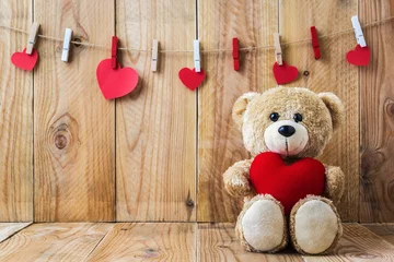 Foto op Plexiglas Teddy bear holding a heart-shaped pillow © aireo