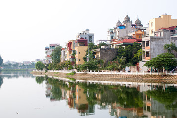 Fototapeta premium Ladnscape of Hanoi with buildings reflected in the river