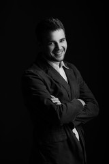 Young handsome man in a jacket on a black background. Studio shoot. 