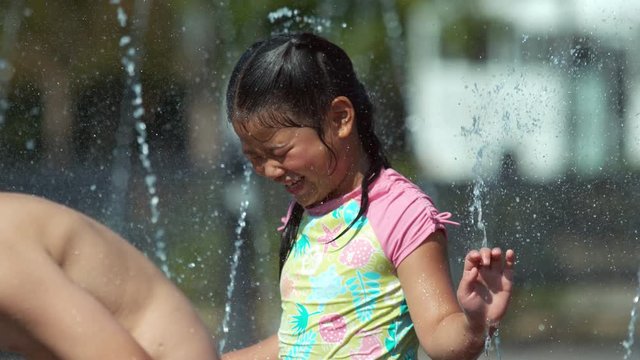 Girl playing in foutain, Slow motion