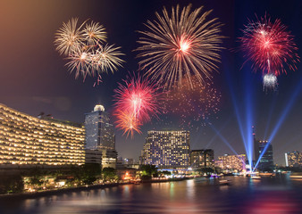 Celebration Fireworks over the river with bangkok cityscape at night scene
