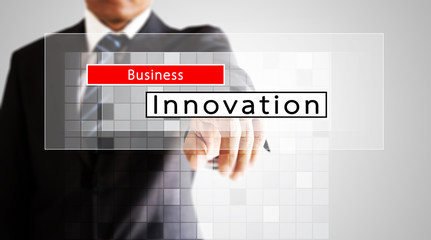 Businessman hand pressing on business innovation screen
