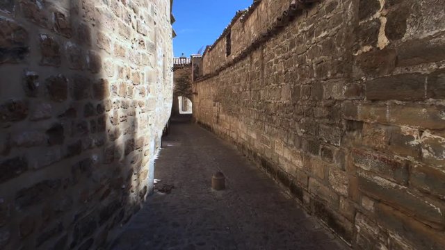 Medieval neighborhood in Baeza, alleyway with stone arch, Jaen province, Andalusia, Spain