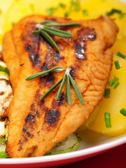 Baked whitefish with orange juice and boiled potatos as side dis