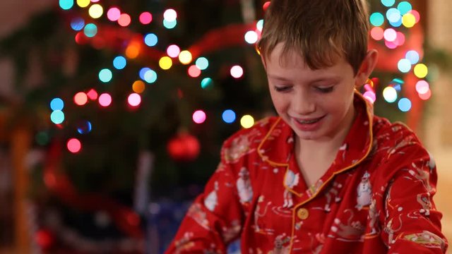 Boy opening Christmas gift and get surprise