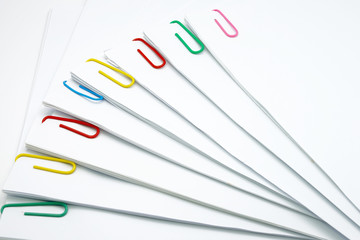 Step pile of document with colorful paperclip