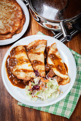 Potato pancakes with meat stew served