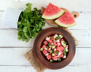 Light refreshing dietary gourmet salad with fresh watermelon, cucumbers and feta cheese.