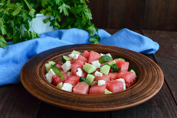 Light refreshing dietary gourmet salad with fresh watermelon, cucumbers and feta cheese.