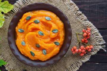 Organic pumpkin puree in a clay bowl. Dietary dish.