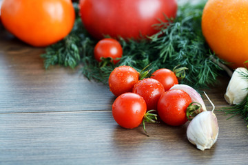 Fresh ripe vegetables on wooden table background