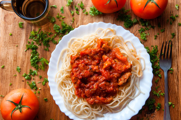 Italian spaghetti and water on a wooden table with text space