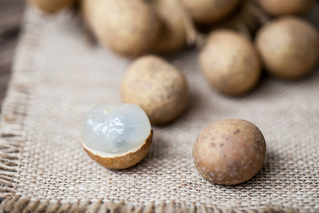 Fresh longan fruits on a wooden background
