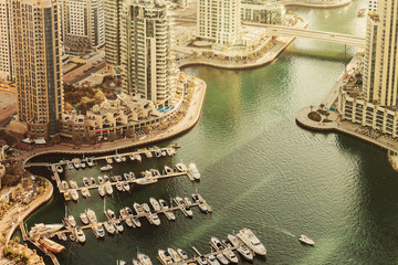 Scenic view over Dubai Marina harbor with boats and yachts. Summer travel background.