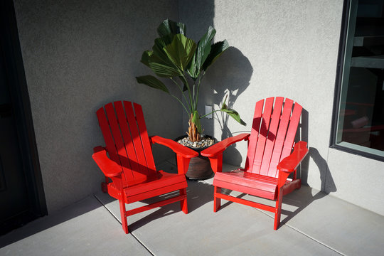2 red chairs on outdoor patio