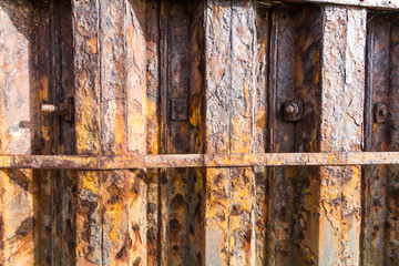 Rust iron girders forming part of harbour wall.