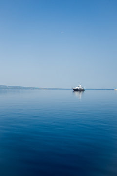 Fototapeta Yacht sails on calm water Adriatic sea