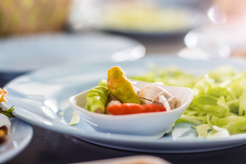 Fresh chilli in wooden bowl on dinner table